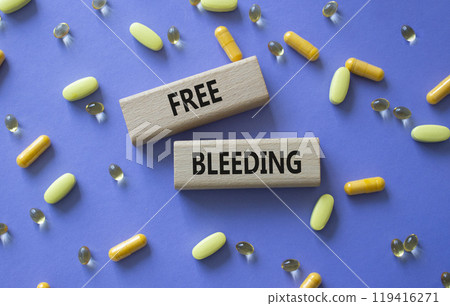 Free bleeding symbol. Concept words Free bleeding on wooden blocks. Beautiful purple background with pills. Motivational and Free bleeding concept. Copy space. 119416271