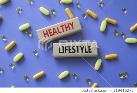Healthy Lifestyle symbol. Concept words Healthy Lifestyle on wooden blocks. Beautiful purple background with pills. Medicine and Healthy Lifestyle concept. Copy space. Healthy Lifestyle symbol. Concept words Healthy Lifestyle on wooden blocks. Beautiful purple background with pills. Medicine and Healthy Lifestyle concept. Copy space. 119416272