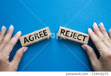 Agree or Reject symbol. Concept word Agree or Reject on wooden blocks. Businessman hand. Beautiful blue background. Gender and Agree or Reject concept. Copy space Agree or Reject symbol. Concept word Agree or Reject on wooden blocks. Businessman hand. Beautiful blue background. Gender and Agree or Reject concept. Copy space 119416275