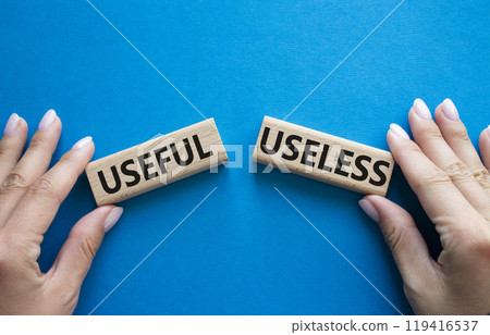 Useful or Useless symbol. Concept word Useful or Useless on wooden blocks. Businessman hand. Beautiful blue background. Business and Useful or Useless concept. Copy space Useful or Useless symbol. Concept word Useful or Useless on wooden blocks. Businessman hand. Beautiful blue background. Business and Useful or Useless concept. Copy space 119416537