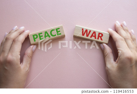 War or Peace symbol. Concept word War or Peace on wooden blocks. Businessman hand. Beautiful pink background. Business and War or Peace concept. Copy space 119416553