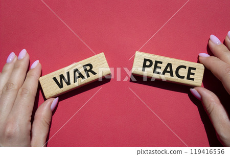 War or Peace symbol. Concept word War or Peace on wooden blocks. Businessman hand. Beautiful red background. Business and War or Peace concept. Copy space 119416556