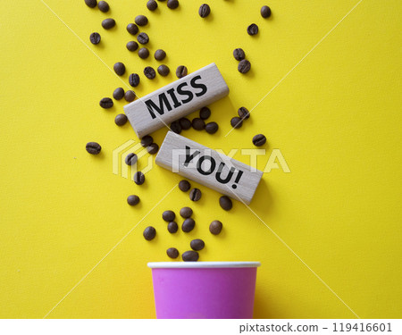Miss you. Concept word Miss you on wooden cubes. Beautiful yellow background with coffee cup. Business and Miss you concept. Copy space. 119416601