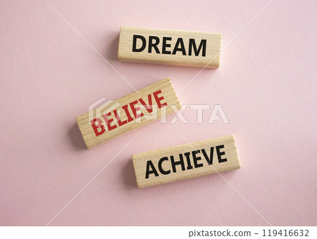 Dream Believe Achieve symbol. Concept words Dream Believe Achieve on wooden blocks. Beautiful pink background. Business and Dream Believe Achieve concept. Copy space 119416632