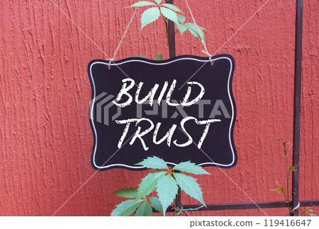 Build trust symbol. Build trust on chalk blackboard. Beautiful red background. Business and Build trust concept. Copy space. Build trust symbol. Build trust on chalk blackboard. Beautiful red background. Business and Build trust concept. Copy space. 119416647