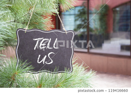 Tell us symbol. Concept words Tell us on black chalk blackboard. Beautiful background with shop and tree. Business and Tell us concept. Copy space. Tell us symbol. Concept words Tell us on black chalk blackboard. Beautiful background with shop and tree. Business and Tell us concept. Copy space. 119416660