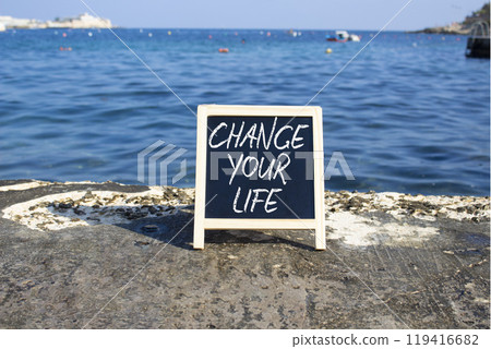Change your Life symbol. Blackboard with words Change your Life. Beautiful sea background. Business and Change your Life concept. Copy space. Change your Life symbol. Blackboard with words Change your Life. Beautiful sea background. Business and Change your Life concept. Copy space. 119416682