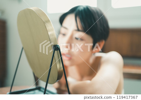 A young woman suffering from skin problems A young woman suffering from skin problems 119417367