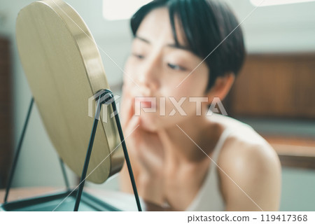 A young woman suffering from skin problems 119417368