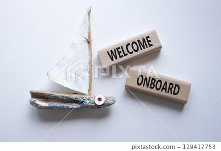 Welcome onboard symbol. Concept words Welcome onboard on wooden blocks. Beautiful white background with boat. Business and Welcome onboard concept. Copy space. Welcome onboard symbol. Concept words Welcome onboard on wooden blocks. Beautiful white background with boat. Business and Welcome onboard concept. Copy space. 119417753