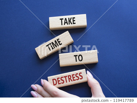 Take time to Destress symbol. Wooden blocks with words Take time to Destress. Beautiful deep blue background. Businessman hand. Business and Take time to Destress concept. Copy space. Take time to Destress symbol. Wooden blocks with words Take time to Destress. Beautiful deep blue background. Businessman hand. Business and Take time to Destress concept. Copy space. 119417789