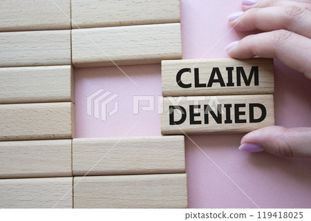 Claim denied symbol. Wooden blocks with words Claim denied. Businessman hand. Beautiful pink background. Business and Claim denied concept. Copy space. Claim denied symbol. Wooden blocks with words Claim denied. Businessman hand. Beautiful pink background. Business and Claim denied concept. Copy space. 119418025