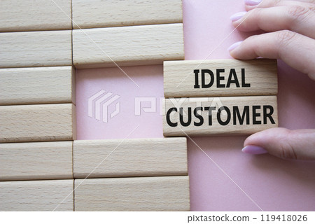 Ideal Customer symbol. Wooden blocks with words Ideal Customer. Businessman hand. Beautiful pink background. Business and Ideal Customer concept. Copy space. Ideal Customer symbol. Wooden blocks with words Ideal Customer. Businessman hand. Beautiful pink background. Business and Ideal Customer concept. Copy space. 119418026