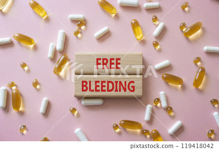 Free bleeding symbol. Concept words Free bleeding on wooden blocks. Beautiful pink background with pills. Motivational and Free bleeding concept. Copy space. 119418042