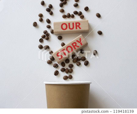 Our story symbol. Wooden blocks with words Our story Beautiful white background with coffee cup and coffee beans. Business and Our story concept. Copy space. Our story symbol. Wooden blocks with words Our story Beautiful white background with coffee cup and coffee beans. Business and Our story concept. Copy space. 119418139