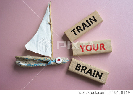 Train Your Brain symbol. Concept words Train Your Brain on wooden blocks. Beautiful pink background with boat. Healthcare and Train Your Brain concept. Copy space. Train Your Brain symbol. Concept words Train Your Brain on wooden blocks. Beautiful pink background with boat. Healthcare and Train Your Brain concept. Copy space. 119418149
