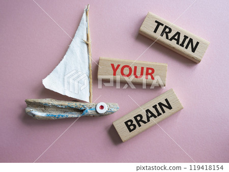 Train Your Brain symbol. Concept words Train Your Brain on wooden blocks. Beautiful pink background with boat. Healthcare and Train Your Brain concept. Copy space. Train Your Brain symbol. Concept words Train Your Brain on wooden blocks. Beautiful pink background with boat. Healthcare and Train Your Brain concept. Copy space. 119418154