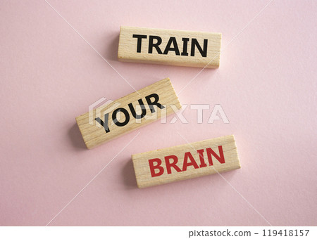 Train Your Brain symbol. Concept words Train Your Brain on wooden blocks. Beautiful pink background. Businessman hand. Business and Train Your Brain concept. Copy space. Train Your Brain symbol. Concept words Train Your Brain on wooden blocks. Beautiful pink background. Businessman hand. Business and Train Your Brain concept. Copy space. 119418157