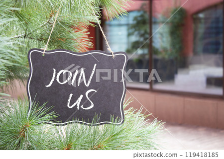 Join us symbol. Concept word Join us on black chalk background. Beautiful background with shop and trees. Business and Join us concept. Copy space Join us symbol. Concept word Join us on black chalk background. Beautiful background with shop and trees. Business and Join us concept. Copy space 119418185