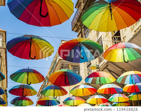 Pink street with colorful rainbow umbrellas, Lisbon, Portugal 119418828