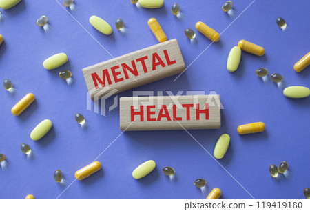 Mental Health symbol. Concept word Mental Health on wooden blocks. Beautiful purple background with pills. Medicine and Mental Health concept. Copy space Mental Health symbol. Concept word Mental Health on wooden blocks. Beautiful purple background with pills. Medicine and Mental Health concept. Copy space 119419180