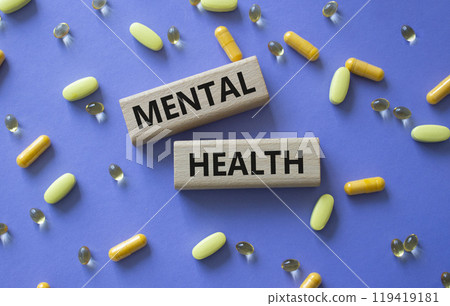 Mental Health symbol. Concept word Mental Health on wooden blocks. Beautiful purple background with pills. Medicine and Mental Health concept. Copy space Mental Health symbol. Concept word Mental Health on wooden blocks. Beautiful purple background with pills. Medicine and Mental Health concept. Copy space 119419181