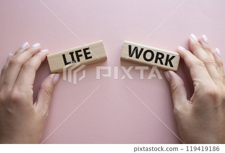 Life or Work symbol. Concept word Life or Work on wooden blocks. Businessman hand. Beautiful pink background. Business and Life or Work concept. Copy space Life or Work symbol. Concept word Life or Work on wooden blocks. Businessman hand. Beautiful pink background. Business and Life or Work concept. Copy space 119419186