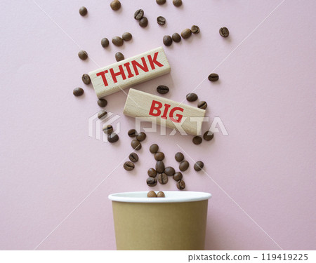 Think big symbol. Wooden blocks with words Think big. Beautiful pink background with coffee cup. Business and Think big concept. Copy space. 119419225