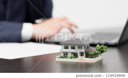 Hands of a businessman creating real estate documents 119419949