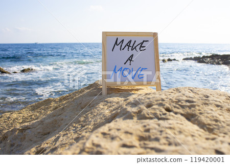 Make a Move symbol. White Blackboard with Concept words Make a Move. Beautiful sea background. Business and Make a Move concept. Copy space. 119420001