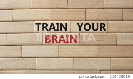 Train Your Brain symbol. Concept words Train Your Brain on wooden blocks. Beautiful wooden background. Businessman hand. Business and Train Your Brain concept. Copy space. 119420019