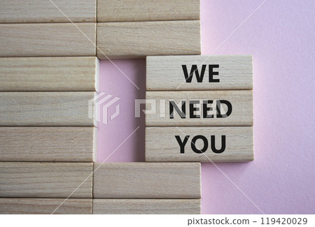 We need you symbol. Concept words We need you on wooden blocks. Beautiful pink background. Business and We need you concept. Copy space. 119420029