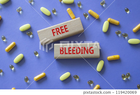 Free bleeding symbol. Concept words Free bleeding on wooden blocks. Beautiful purple background with pills. Motivational and Free bleeding concept. Copy space. Free bleeding symbol. Concept words Free bleeding on wooden blocks. Beautiful purple background with pills. Motivational and Free bleeding concept. Copy space. 119420069