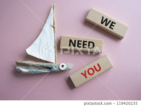 We need you symbol. Concept words We need you on wooden blocks. Beautiful pink background with boat. Business and We need you concept. Copy space. 119420235