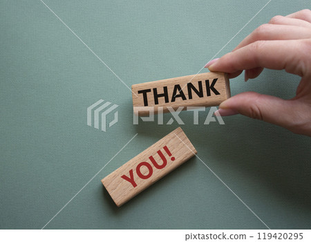 Thank you symbol. Wooden blocks with words Thank you. Businessman hand. Beautiful grey green background. Business and Thank you concept. Copy space. Thank you symbol. Wooden blocks with words Thank you. Businessman hand. Beautiful grey green background. Business and Thank you concept. Copy space. 119420295