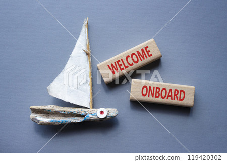 Welcome onboard symbol. Concept words Welcome onboard on wooden blocks. Beautiful grey background with boat. Business and Welcome onboard concept. Copy space. Welcome onboard symbol. Concept words Welcome onboard on wooden blocks. Beautiful grey background with boat. Business and Welcome onboard concept. Copy space. 119420302