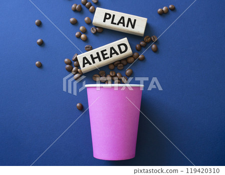 Plan ahead symbol. Wooden blocks with words Plan ahead. Beautiful deep blue background with coffee cup and coffee beans. Business and Plan ahead concept. Copy space. 119420310