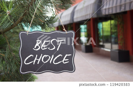Best choice symbol. Blackboard with words Best choice. Beautiful background with shop and tree. Business and Best choice concept. Copy space. 119420383