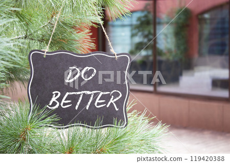 Do Better symbol. Do Better black chalk blackboard. Beautiful background with shop and tree. Business and Do Better concept. Copy space. 119420388