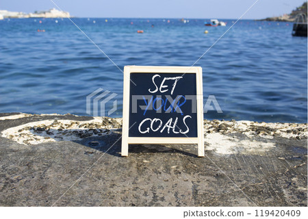 Set your Goals symbol. Blackboard with Concept words Set your Goals. Beautiful sea background. Business and Set your Goals concept. Copy space. 119420409