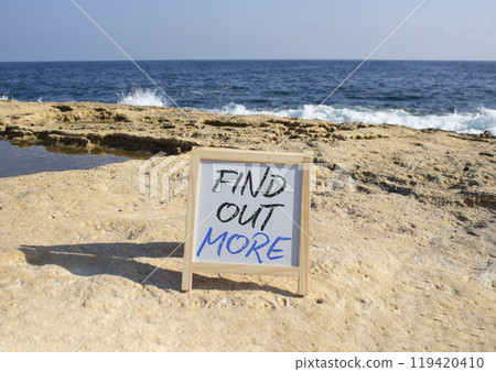 Find out more symbol. White Blackboard with words Find out more. Beautiful sea background. Business and Find out more concept. Copy space. 119420410