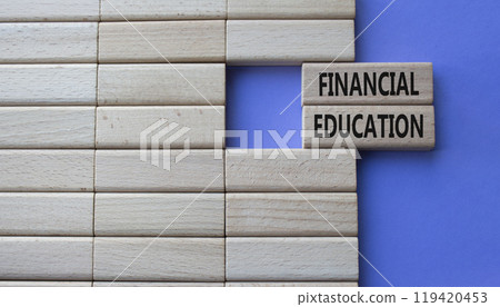 Financial Education symbol. Concept word Financial Education on wooden blocks. Beautiful purple background. Business and Financial Education concept. Copy space Financial Education symbol. Concept word Financial Education on wooden blocks. Beautiful purple background. Business and Financial Education concept. Copy space 119420453