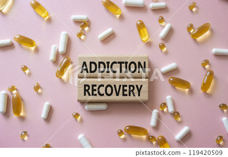 Addiction Recovery symbol. Concept words Addiction Recovery on wooden blocks. Beautiful pink background with pills. Medicine and Addiction Recovery concept. Copy space. Addiction Recovery symbol. Concept words Addiction Recovery on wooden blocks. Beautiful pink background with pills. Medicine and Addiction Recovery concept. Copy space. 119420509