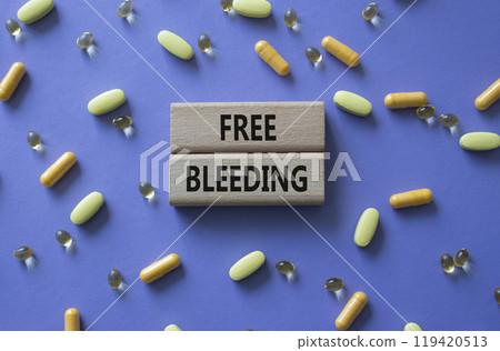 Free bleeding symbol. Concept words Free bleeding on wooden blocks. Beautiful purple background with pills. Motivational and Free bleeding concept. Copy space. Free bleeding symbol. Concept words Free bleeding on wooden blocks. Beautiful purple background with pills. Motivational and Free bleeding concept. Copy space. 119420513