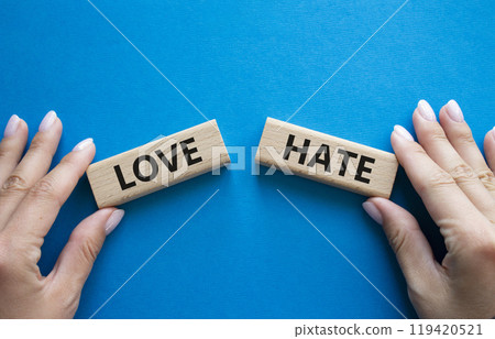 Love vs Hate symbol. Concept word Love vs Hate on wooden blocks. Businessman hand. Beautiful blue background. Business and Love vs Hate concept. Copy space Love vs Hate symbol. Concept word Love vs Hate on wooden blocks. Businessman hand. Beautiful blue background. Business and Love vs Hate concept. Copy space 119420521