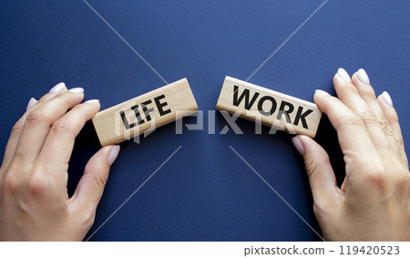 Life or Work symbol. Concept word Life or Work on wooden blocks. Businessman hand. Beautiful deep blue background. Business and Life or Work concept. Copy space 119420523