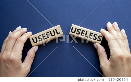 Useful or Useless symbol. Concept word Useful or Useless on wooden blocks. Businessman hand. Beautiful deep blue background. Business and Useful or Useless concept. Copy space 119420524