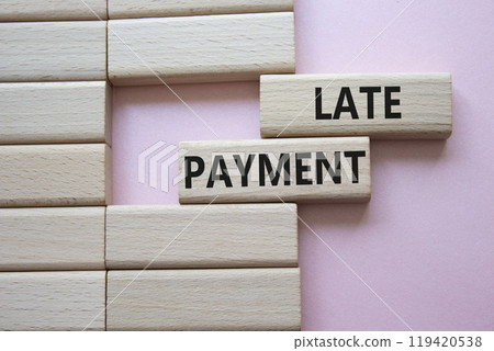 Late payment symbol. Concept word Late payment on wooden blocks. Beautiful pink background. Business and Late payment concept. Copy space 119420538
