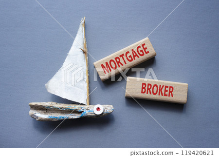 Mortgage Broker symbol. Concept word Mortgage Broker on wooden blocks. Beautiful grey background with boat. Business and Mortgage Broker concept. Copy space Mortgage Broker symbol. Concept word Mortgage Broker on wooden blocks. Beautiful grey background with boat. Business and Mortgage Broker concept. Copy space 119420621