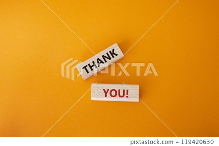Thank you symbol. Wooden blocks with words Thank you. Beautiful orange background. Business and Thank you concept. Copy space. 119420630